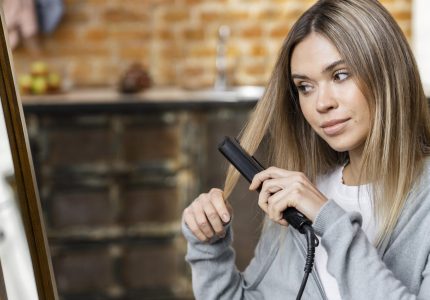 woman-straightening-her-hair-home